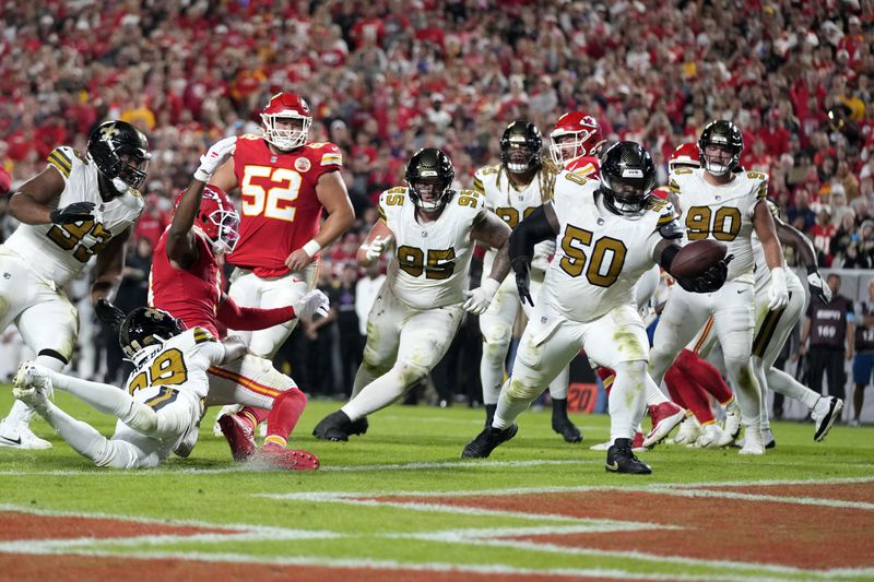 New Orleans Saints defensive tackle Khalen Saunders (50) intercepts a pass in the end zone during the second half of an NFL football game against the Kansas City Chiefs Monday, Oct. 7, 2024, in Kansas City, Mo. (AP Photo/Ed Zurga)