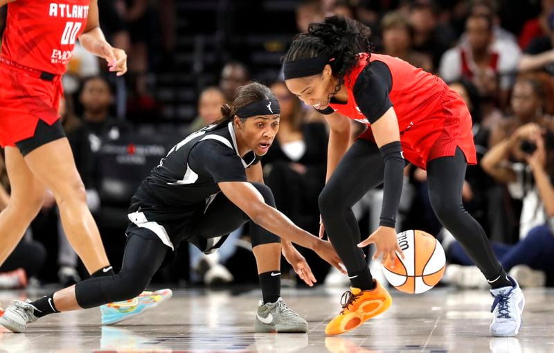 Las Vegas Aces guard Sydney Colson (51) tries to steal the ball from Atlanta Dream guard Jordin Canada (3) during the first half of an WNBA basketball game Friday, Aug. 30, 2024 in Las Vegas. (Steve Marcus/Las Vegas Sun via AP)