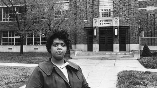 FILE - This May 8, 1964 file photo shows Linda Brown Smith standing in front of the Sumner School in Topeka, Kansas. The refusal of the public school to admit Brown in 1951, when she was 9 years old, led to the Brown v. Board of Education of Topeka, Kansas lawsuit. In 1954, the U.S. Supreme Court mandated that schools nationwide must be desegregated.  (AP Photo, File)