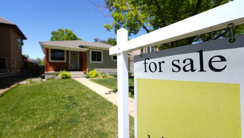 FILE - A for sale sign stands outside a single-family residence on the market Wednesday, May 22, 2024, in southeast Denver. (AP Photo/David Zalubowski, File)