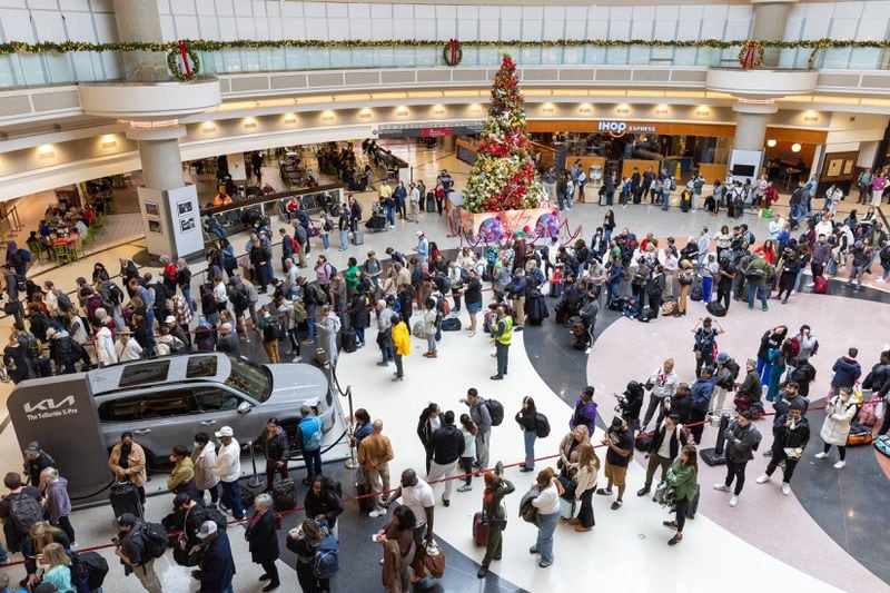 Travelers wait in long lines at the domestic terminal of Hartsfield-Jackson airport in Atlanta on Tues., Dec. 26, 2023, the day after Christmas. (Arvin Temkar / arvin.temkar@ajc.com)