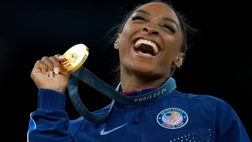 Simone Biles, of the United States, celebrates after winning the gold medal at the medal ceremony during the women's artistic gymnastics individual vault finals at Bercy Arena at the 2024 Summer Olympics, Saturday, Aug. 3, 2024, in Paris, France. (AP Photo/Francisco Seco)