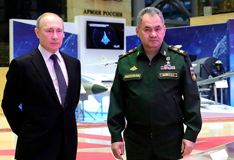 Russian President Vladimir Putin, left, and Defense Minister Sergei Shoigu speak to journalists after attending an annual meeting with top military officials Dec. 24 in the National Defense Control Center in Moscow.