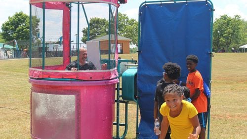 Kennesaw Police Chief Bill Westenberger smiles after being dunked in water by a group of children at the fourth annual “Unity in the Community: A Juneteenth Celebration of Unity” event on Saturday at Swift-Cantrell Park in Kennesaw, Georgia. (Photo Courtesy of Zeke Palermo)