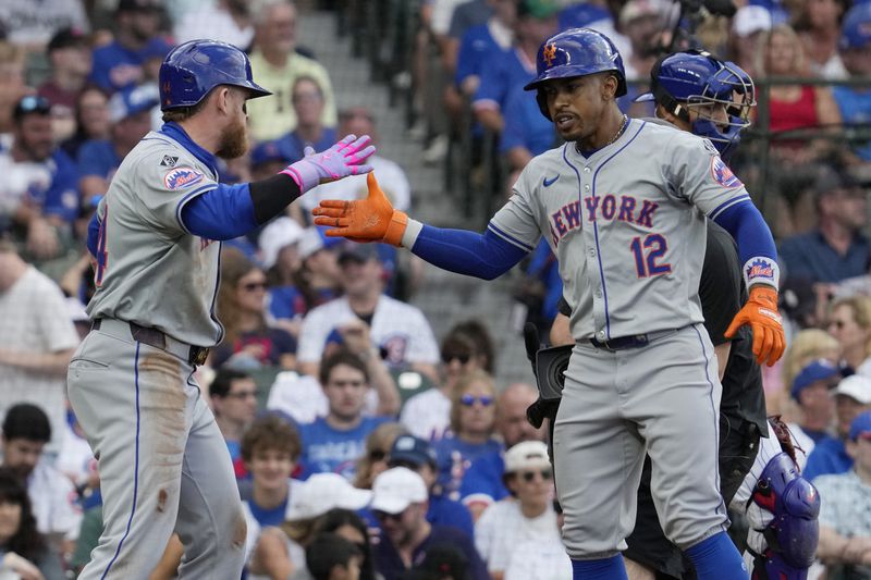 New York Mets' Francisco Lindor, right, celebrates with Harrison Bader, left, after hitting a two-run home run during the third inning of a baseball game against the Chicago Cubs in Chicago, Sunday, June 23, 2024. (AP Photo/Nam Y. Huh)