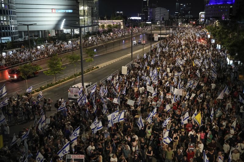People protest against Israeli Prime Minister Benjamin Netanyahu's government and call for the release of hostages held in the Gaza Strip by the Hamas militant group, in Tel Aviv, Israel, Saturday, June 22, 2024. (AP Photo/Leo Correa)