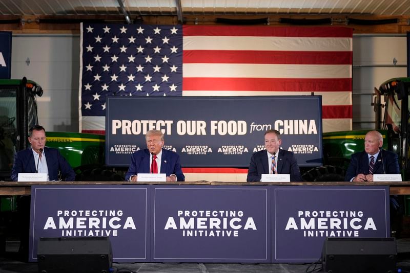 Republican presidential nominee former President Donald Trump speaks at a campaign event at a farm, Monday, Sept. 23, 2024, in Smithton, Pa, as from left, Richard Grenell, Lee Zelda and Rep. Glenn Thompson, R-Pa., listen. (AP Photo/Alex Brandon)