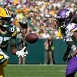 Green Bay Packers wide receiver Romeo Doubs (87) makes a catch past Minnesota Vikings cornerback Shaq Griffin, right, during the first half of an NFL football game Sunday, Sept. 29, 2024, in Green Bay, Wis. (AP Photo/Morry Gash)