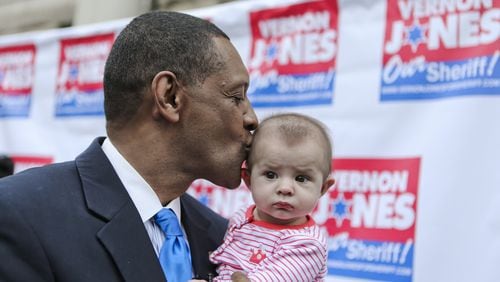 Vernon Jones kisses 5-month old, Harper Gonzales, daughter of Mario and Jacqueline Gonzales. Former DeKalb CEO Vernon Jones made an expected announcement Thursday, Feb. 20, 2014 on the steps of the old DeKalb County Courthouse in Decatur formally unveiling his campaign for DeKalb County sheriff. JOHN SPINK/JSPINK@AJC.COM