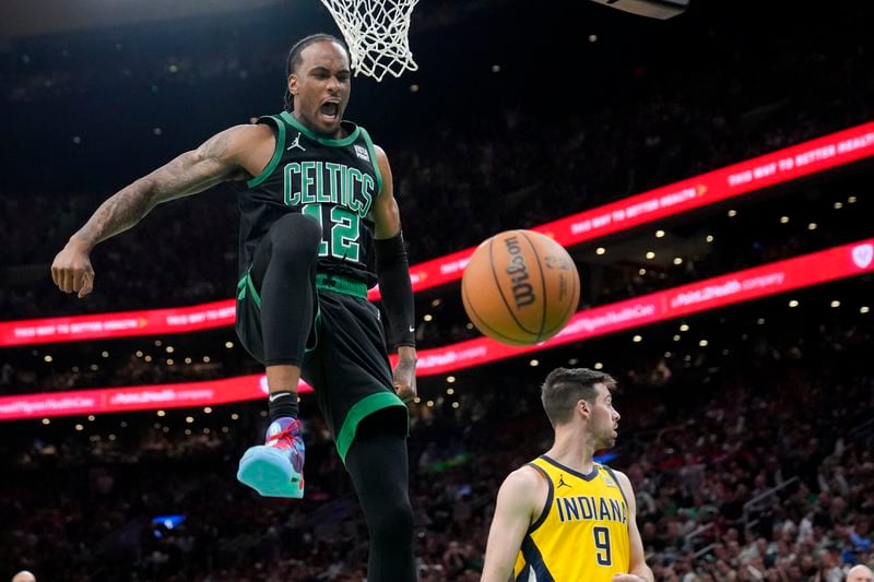 Boston Celtics forward Oshae Brissett (12) celebrates after dunking against the Indiana Pacers during the second half of Game 2 of the NBA Eastern Conference basketball finals Thursday, May 23, 2024, in Boston. (AP Photo/Steven Senne)