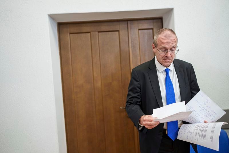 Doctor Hans Henri P. Kluge, WHO Regional Director for Europe, reads notes before a press conference in Kyiv, Ukraine, Thursday Sept. 12, 2024. (AP Photo/Evgeniy Maloletka)