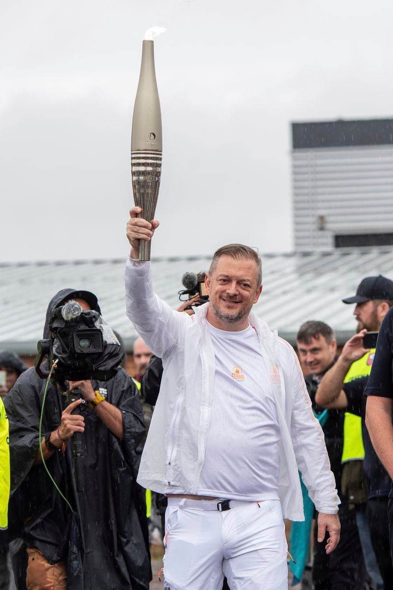 International Paralympic Committee (IPC) President Andrew Parsons holds up the Paralympic Torch during the flame lighting ceremony in Stoke Mandeville, widely considered the birthplace of the Paralympic Games, England, Saturday, Aug. 24, 2024. (AP Photo/Thomas Krych)