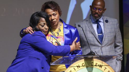 Bernice King, center, gets a hug from Angela Farris Watkins during a press conference on the passing of her brother, Dexter Scott King, son of Dr. Martin Luther King, Jr. at the Yolanda D. King Theatre for the Performing Arts, Tuesday, January 23, 2024. Also pictured is King Estate General Council Eric Tidwell. (Jason Getz/jason.getz@ajc.com)