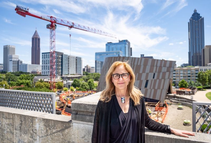 CEO Jill Savitt poses in a parking structure overlooking construction at the Center for Civil and Human Rights in Atlanta on Thursday, July 11, 2024. (Seeger Gray / AJC)