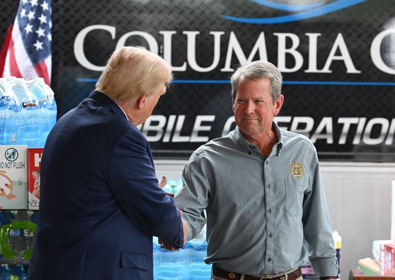 Former President Donald Trump greets Gov. Brian Kemp in Evans on Friday.