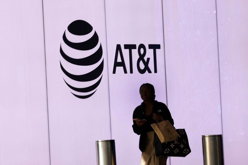 A woman walks by an AT&T logo at AT&T Discovery District in downtown Dallas,Thursday, Feb. 22, 2024, in Dallas. (Chitose Suzuki/The Dallas Morning News/TNS)