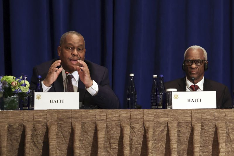 Haitian Prime Minister Garry Conille, left, speaks as President of the Haitian Transitional Presidential Council Edgard Leblanc Fils, right, and others listen during a Multilateral Meeting on Building on Progress to Restore Security in Haiti in New York, Wednesday, Sept. 25, 2024. (Caitlin Ochs/Pool Photo via AP)