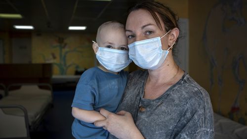 Oksana Halak poses for a portrait with her son Dmytro, 2, at the National Cancer Institute in Kyiv, Ukraine, Wednesday, July 10, 2024. Dmytro is one of 31 young patients battling cancer who were relocated to the hospital from Okhmatdyt Children’s Hospital after it was struck by a Russian missile this week. (AP Photo/Alex Babenko)