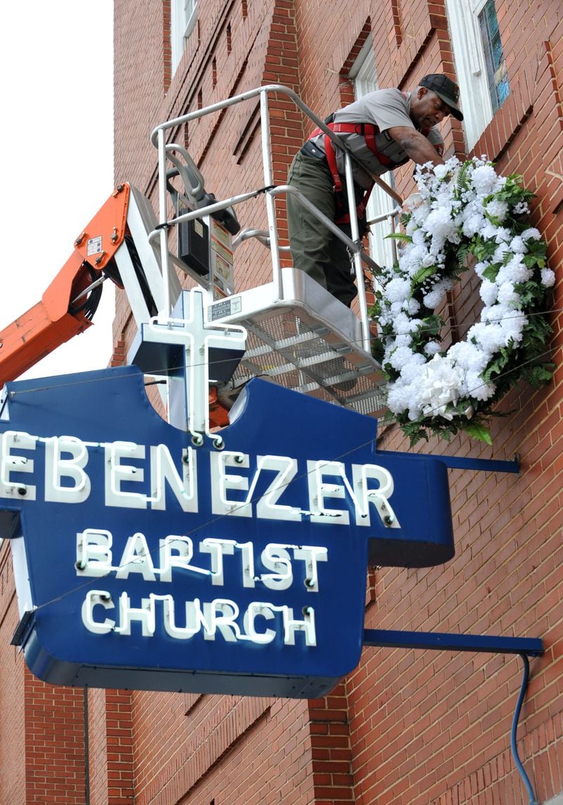 A National Park Service worker installed the wreath on the front of Ebenezer Baptist Church on the 46th anniversary of King's assassination on April 4, 2014.  (Kent Johnson)