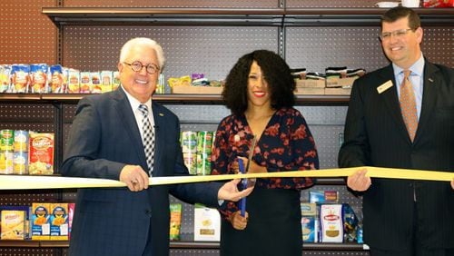 Five workshops will be offered by Cobb County in February and March to help officials from nonprofit organizations understand how to fill out grant applications for consideration of county grants. Among the recipients of Cobb funding has been MUST Ministries. Participating in a recent opening of MUST’s 30th school food pantry were (l-r) MUST Ministries President and CEO Dr. Dwight “Ike” Reighard, Garrett Middle School Principal Kimberly Jackson and Drew Shambarger, chairman of the MUST Ministries Board of Directors and the Market President for BB&T Northwest Atlanta. (Courtesy of the Cobb County School District)