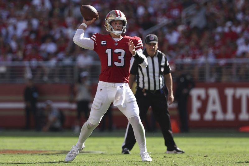 San Francisco 49ers quarterback Brock Purdy (13) passes against the Arizona Cardinals during the second half of an NFL football game in Santa Clara, Calif., Sunday, Oct. 6, 2024. (AP Photo/Jed Jacobsohn)