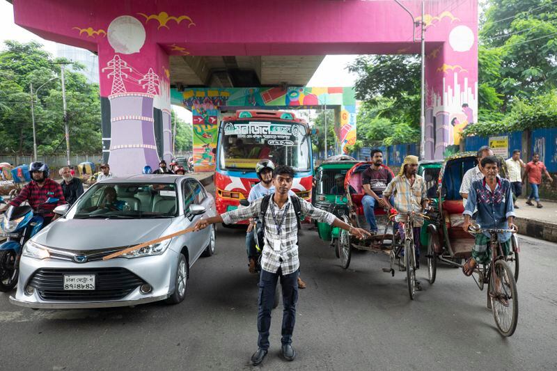 A student directs traffic in Dhaka, Bangladesh, on Aug. 8, 2024. (AP Photo/Rajib Dhar)