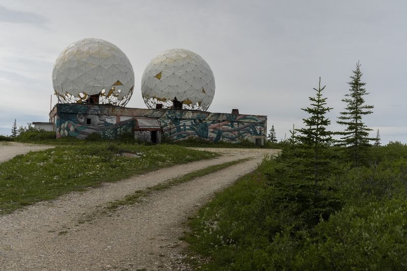 Two large domes stand atop an abandoned radar station, Sunday, Aug. 4, 2024, in Churchill, Manitoba. (AP Photo/Joshua A. Bickel)