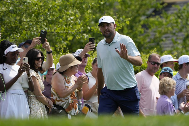 Scottie Scheffler acknowledges the crowd on the first tee during the first round of the Travelers Championship golf tournament at TPC River Highlands, Thursday, June 20, 2024, in Cromwell, Conn. (AP Photo/Seth Wenig)