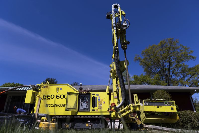 FILE - A drill rig sits outside a home during installation of a geothermal heat pump system in White Plains, N.Y., Monday, May 8, 2023. (AP Photo/Julia Nikhinson, File)