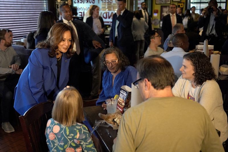 Democratic presidential nominee Vice President Kamala Harris, left, greets customers at Primanti Bros. restaurant during a campaign stop, Sunday, Aug. 18, 2024, in Pittsburgh. (AP Photo/Julia Nikhinson)