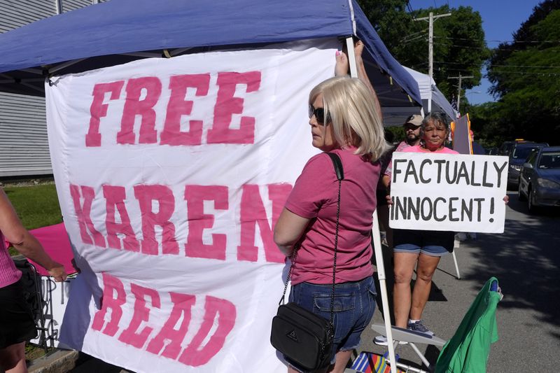 Supporters of Karen Read display signs and a banner a block away from Norfolk Superior Court, Tuesday, June 25, 2024, in Dedham, Mass. Karen Read is on trial, accused of killing her boyfriend Boston police Officer John O'Keefe, in 2022. (AP Photo/Steven Senne)