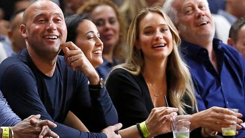 Miami Marlins chief executive and part owner Derek Jeter and wife Hannah Davis watch as the Miami Heat play the Golden State Warriors on December 3, 2017, at AmericanAirlines Arena in Miami. (David Santiago/Miami Herald/TNS)