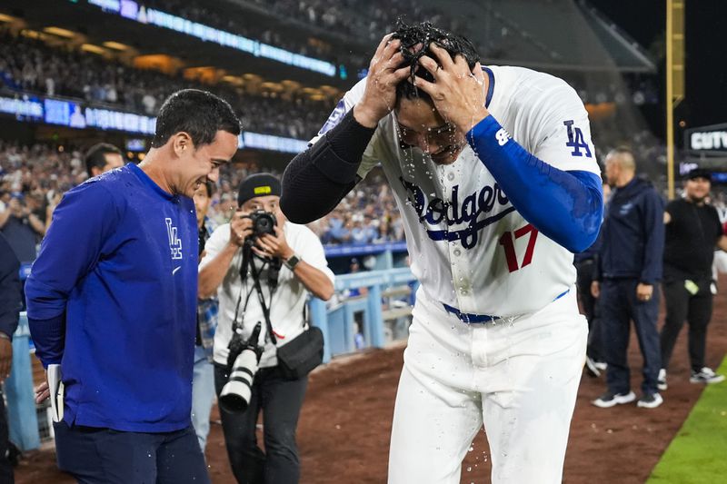 Los Angeles designated hitter Shohei Ohtani (17) reacts after teammates poured drinks on his head after hitting a grand slam during the eighth inning of a baseball game against the Tampa Bay Rays in Los Angeles, Friday, Aug. 23, 2024. Will Smith, Tommy Edman, and Max Muncy also scored. The Dodgers won 7-3. (AP Photo/Ashley Landis)