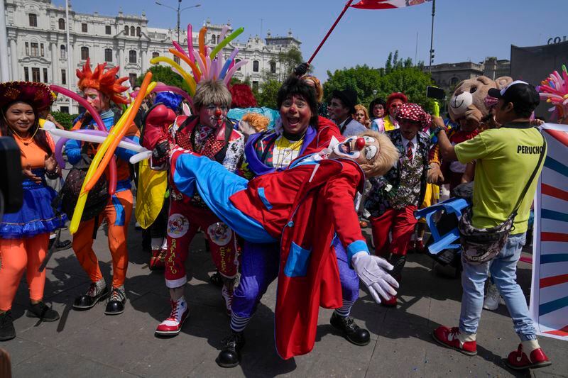 Clowns gather in the San Martin plaza to celebrate The Day of the Peruvian Clown, in Lima, Peru, Saturday, May 25, 2024. Professional clowns gather annually on this date to honor the beloved clown "Tony Perejil" who died on May 25, 1987 and was known as "the clown of the poor" because he performed in low-income neighborhoods to which he would donate a portion of his earnings. (AP Photo/Martin Mejia)