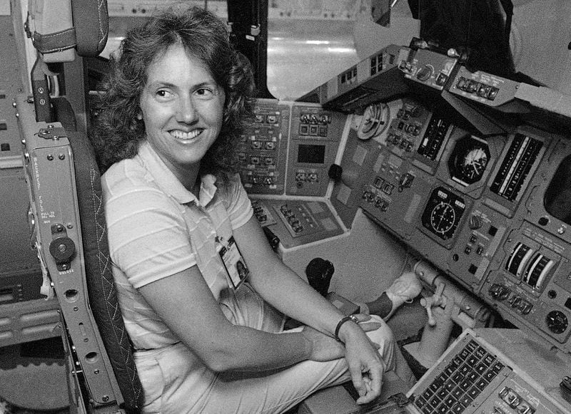 FILE - In this Sept. 13, 1985 file photo, Christa McAuliffe tries out the commander's seat on the flight deck of a shuttle simulator at the Johnson Space Center in Houston, Texas. (AP Photo, File)