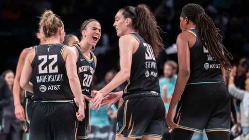 New York Liberty guard Sabrina Ionescu (20) celebrates with forward Breanna Stewart (30) during the second half of a WNBA basketball second-round playoff game against the Las Vegas Aces, Sunday, Sept. 29, 2024, in New York. (AP Photo/Corey Sipkin)