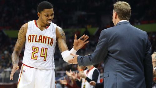 Hawks’ Kent Bazemore gives head coach Mike Budenholzer five during the final minute of a 102-98 victory over the Knicks in a NBA basketball game on Wednesday, Dec. 28, 2016, in Atlanta. Curtis Compton/ccompton@ajc.com