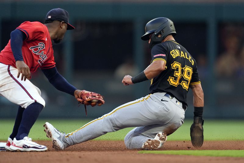 Pittsburgh Pirates' Nick Gonzales (39) steals second base ahead of the throw to Atlanta Braves second baseman Ozzie Albies (1) in the second inning of a baseball game Friday, June 28, 2024, in Atlanta. (AP Photo/John Bazemore)