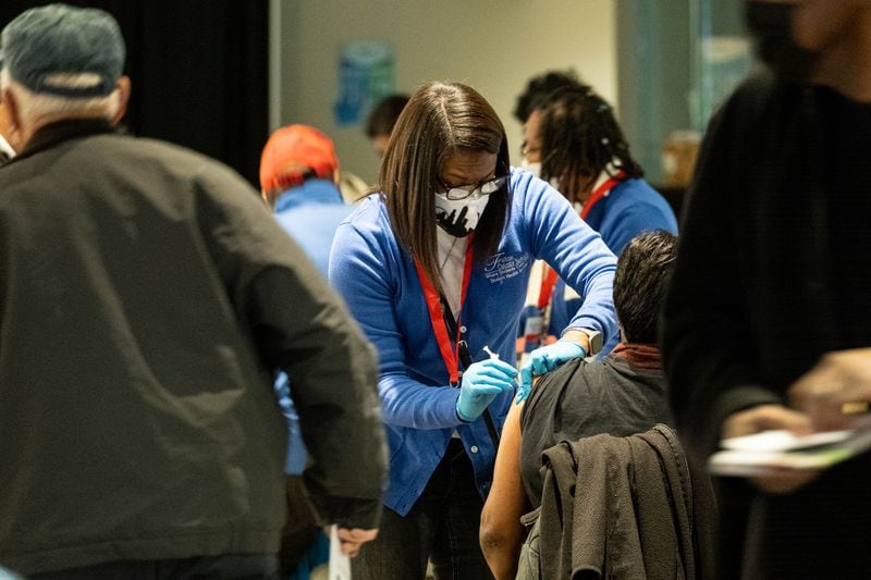 210116-Atlanta- Registered nurse Aleve Reed administers a COVID-19 vaccine during an event Saturday morning, Jan. 16, 2021, at Mercedes-Benz Stadium for Fulton County School employees and their spouses who are 65 and older. (Photo: Ben Gray for The Atlanta Journal-Constitution)