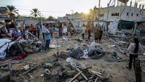 Palestinians inspect the damage at a tent area in the courtyard of Al Aqsa Martyrs hospital, hit by an Israeli bombardment on Deir al-Balah, central Gaza Strip, Thursday, Sept. 5, 2024. (AP Photo/Abdel Kareem Hana)