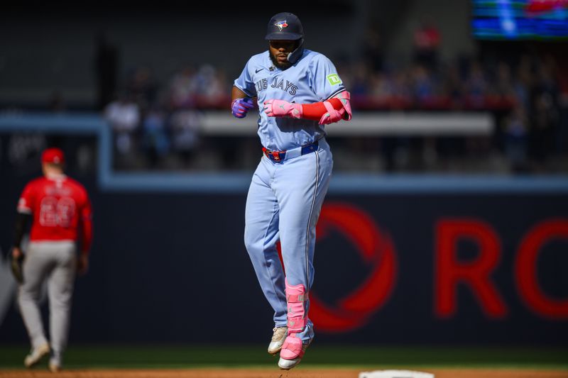 Toronto Blue Jays' Vladimir Guerrero Jr. celebrates after hitting a home run during the eighth inning of a baseball game against the Los Angeles Angels in Toronto, Saturday, Aug. 24, 2024. (Christopher Katsarov/The Canadian Press via AP)