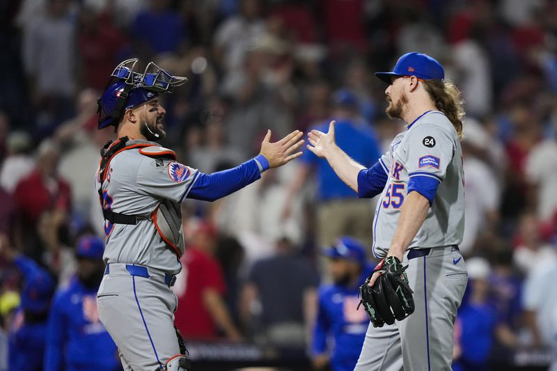 New York Mets' Ryne Stanek, right, and Luis Torrens celebrate after they won Game 1 of a baseball NL Division Series against the Philadelphia Phillies, Saturday, Oct. 5, 2024, in Philadelphia. (AP Photo/Matt Slocum)