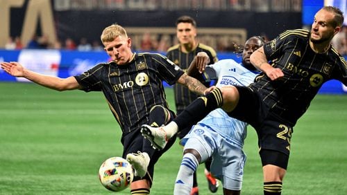 Atlanta United midfielder Tristan Muyumba (center) battles Los Angeles FC midfielder Mateusz Bogusz (left) and Los Angeles FC defender Maxime Chanot for the ball during the first half in a MLS soccer match at Mercedes-Benz Stadium, Saturday, May 25, 2024, in Atlanta. Los Angeles FC won 1-0 over Atlanta United. (Hyosub Shin / AJC)