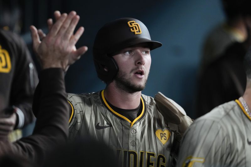 San Diego Padres' Jackson Merrill celebrates in the dugout after scoring as Jake Cronenworth ground out during the second inning of a baseball game against the Los Angeles Dodgers in Los Angeles, Wednesday, Sept. 25, 2024. (AP Photo/Ashley Landis)