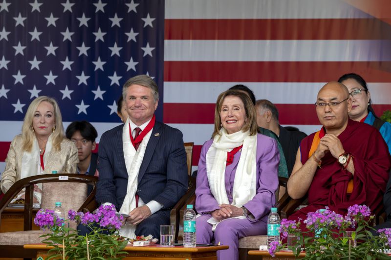 Republican Rep. Michael McCaul, left, and Democratic former House Speaker Nancy Pelosi sit in the front row with Khenpo Sonam Tenphel, Speaker of the Tibetan parliament-in-exile, at a public event during which they were felicitated by the President of the Central Tibetan Administration and other officials at the Tsuglakhang temple in Dharamshala, India, Wednesday, June 19, 2024. (AP Photo/Ashwini Bhatia)