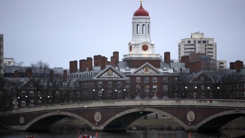 FILE - Rowers paddle down the Charles River near the campus of Harvard University in Cambridge, Mass., March 7, 2017. (AP Photo/Charles Krupa, File)