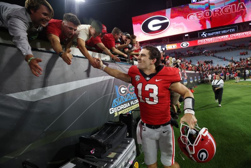 Georgia Bulldogs quarterback Stetson Bennett celebrates their 42-20 win against the Florida Gators in a NCAA football game at TIAA Bank Field, Saturday, October 29, 2022, in Jacksonville, Florida. (Jason Getz / Jason.Getz@ajc.com)