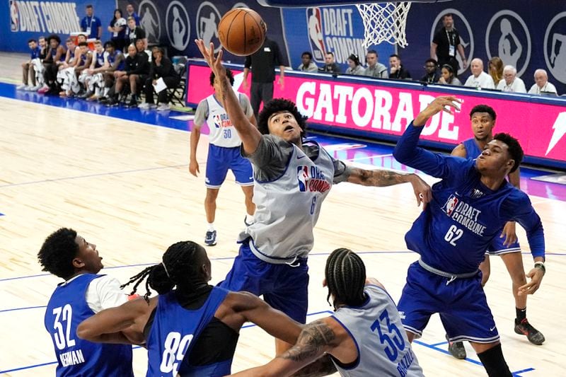FILE - Team Herscu's Izan Almansa, center, reaches for a rebound as Team Forehn-Kelly's Ulrich Chomche (62) watches during the NBA draft combine 5-on-5 basketball game in Chicago, on May 15, 2024. (AP Photo/Nam Y. Huh, File)