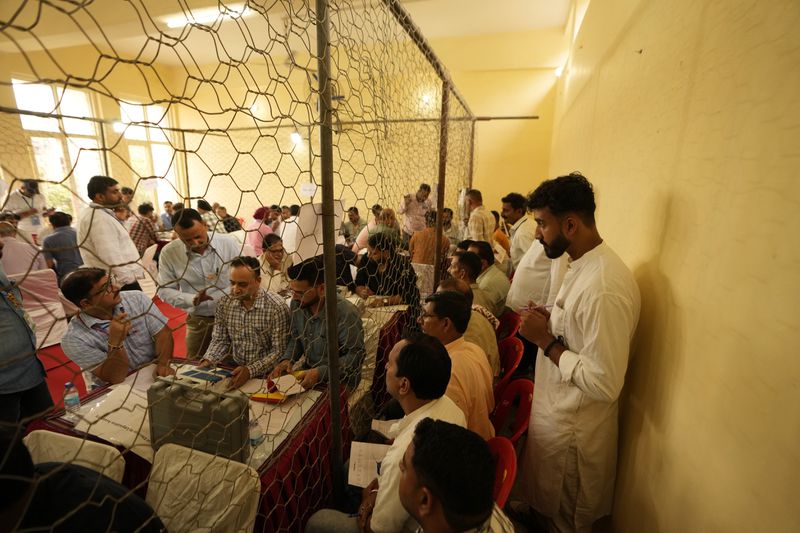 Election officers count votes for the recent election at a counting center in Jammu, India, Tuesday, Oct. 8, 2024. (AP Photo/Channi Anand)