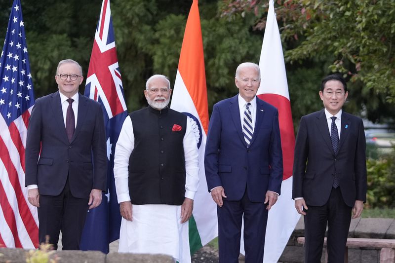 President Joe Biden, joined by Australia's Prime Minister Anthony Albanese, Japan's Prime Minister Fumio Kishida, and India's Prime Minister Narendra Modi, stand for a group photo before speaking about a Quadrilateral Cancer Moonshot initiative on the sidelines of the Quad leaders summit at Archmere Academy in Claymont, Del., Saturday, Sept. 21, 2024. (AP Photo/Mark Schiefelbein)